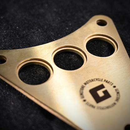 Backside of Kawasaki Vulcan 800 dash plaque made out of raw brass with the Gemstone Motorcycle Parts logo laser engraved.