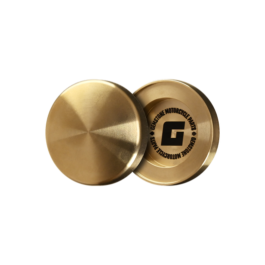 Isolated image of a pair of Yamaha Wildstar 1600 Fork Bolt Caps made out of raw brass.